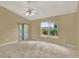 Spacious bedroom featuring large windows and neutral carpeting at 9290 Lake Sharp Ct, Orlando, FL 32817