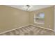 Bedroom featuring neutral carpet, ceiling fan, and a window with a view at 9290 Lake Sharp Ct, Orlando, FL 32817