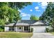 Charming single-story home featuring a well-maintained lawn and attached two-car garage at 9290 Lake Sharp Ct, Orlando, FL 32817