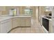Well-lit kitchen with appliances, tile floors, and white cabinets at 9290 Lake Sharp Ct, Orlando, FL 32817