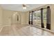 Spacious living room with large windows, tile flooring, and arched doorways at 9290 Lake Sharp Ct, Orlando, FL 32817