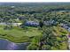 Beautiful aerial view of manicured golf course and luxury homes surrounded by lush trees at 9624 Bryanston Dr, Orlando, FL 32827