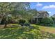 Landscaped backyard featuring a seating area and a view of the home's elegant exterior at 9624 Bryanston Dr, Orlando, FL 32827