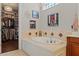 Bathroom features a large soaking tub, and access to walk in closet at 9624 Bryanston Dr, Orlando, FL 32827