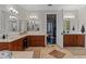 Bright bathroom with double sinks, neutral tile floors and backyard views at 9624 Bryanston Dr, Orlando, FL 32827