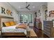 Bright bedroom features modern rustic furniture, backyard views, and a ceiling fan at 9624 Bryanston Dr, Orlando, FL 32827