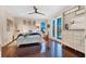 Bright bedroom with polished hardwood floors, white furniture and large windows with sun-filtering blinds at 9624 Bryanston Dr, Orlando, FL 32827