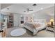 Cozy bedroom with sloped ceilings, a ceiling fan, and a view of an adjoining bathroom at 9624 Bryanston Dr, Orlando, FL 32827