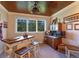 Bonus room features a custom bar with ceiling fan and backyard views at 9624 Bryanston Dr, Orlando, FL 32827