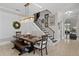 Dining area features a rustic wood table, modern chandelier, and staircase with Gathering photos at 9624 Bryanston Dr, Orlando, FL 32827