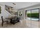 Bright dining room features a modern chandelier, access to the pool, and unique bench style seating at 9624 Bryanston Dr, Orlando, FL 32827