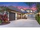 Charming home with a large three-car garage and meticulously maintained landscaping and a tile roof at 9624 Bryanston Dr, Orlando, FL 32827