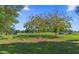 Beautiful golf course scenery with mature trees and golf carts on the lush green fairways at 9624 Bryanston Dr, Orlando, FL 32827