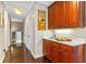 Hallway wet bar features cherry wood cabinets, a sink, and counterspace for easy entertaining at 9624 Bryanston Dr, Orlando, FL 32827
