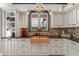 Stylish kitchen featuring a unique copper sink, custom cabinetry, and modern fixtures at 9624 Bryanston Dr, Orlando, FL 32827