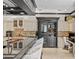 Gourmet kitchen featuring island seating, custom cabinetry, wine storage, and adjacent work space at 9624 Bryanston Dr, Orlando, FL 32827