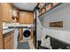 Well-organized laundry room with cabinetry, sink, and modern appliances at 9624 Bryanston Dr, Orlando, FL 32827