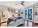Bright main bedroom with wood floors, a ceiling fan and access to the backyard via sliding doors at 9624 Bryanston Dr, Orlando, FL 32827
