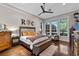 Bright main bedroom with hardwood floors, comfortable king bed and plentiful natural light from multiple windows at 9624 Bryanston Dr, Orlando, FL 32827