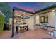 Inviting outdoor kitchen featuring granite countertops, stainless steel grill, and bar stool seating under a pergola at 9624 Bryanston Dr, Orlando, FL 32827