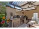 Outdoor kitchen featuring stainless steel grill, granite countertops, and custom cabinetry at 9624 Bryanston Dr, Orlando, FL 32827