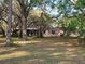 The home features a spacious backyard with mature trees and a screened-in back porch at 9741 Se Highway 464C Se Hwy, Ocklawaha, FL 32179