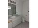 Bright bathroom featuring a single sink vanity, toilet, and window for natural light at 9741 Se Highway 464C Se Hwy, Ocklawaha, FL 32179