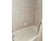 Bathroom with a bathtub and a beige tiled wall at 9741 Se Highway 464C Se Hwy, Ocklawaha, FL 32179