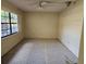 Cozy bedroom featuring a window for natural light and neutral walls at 9741 Se Highway 464C Se Hwy, Ocklawaha, FL 32179