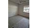 Empty bedroom featuring a ceiling fan, window, and linoleum flooring at 9741 Se Highway 464C Se Hwy, Ocklawaha, FL 32179