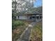 View of the exterior of the home featuring the entrance, walkway, and yard at 9741 Se Highway 464C Se Hwy, Ocklawaha, FL 32179