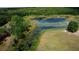 Aerial view of lake showcasing lush aquatic plant life, and grassy shoreline at 9741 Se Highway 464C Se Hwy, Ocklawaha, FL 32179