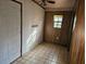 Small room featuring a window, linoleum flooring, and paneled walls at 9741 Se Highway 464C Se Hwy, Ocklawaha, FL 32179