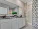 Well-lit bathroom featuring a double vanity with granite countertop, modern fixtures, and a walk-in shower at 11148 Amber Ridge Dr, Zellwood, FL 32798