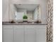 Elegant bathroom showcasing a spacious vanity with granite countertop, contemporary faucets, and stylish mirror at 11148 Amber Ridge Dr, Zellwood, FL 32798