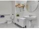 Clean half bathroom featuring a modern sink, round mirror, and neutral colors at 11148 Amber Ridge Dr, Zellwood, FL 32798