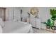 Bright bedroom with a decorative mirror, dresser, and modern decor for a serene and inviting space at 11148 Amber Ridge Dr, Zellwood, FL 32798