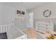 Cozy Bedroom featuring a crib, dresser, and modern decor with a neutral color scheme at 11148 Amber Ridge Dr, Zellwood, FL 32798