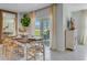 Dining room features seating for six, a large window, and easy access to the outside patio at 11148 Amber Ridge Dr, Zellwood, FL 32798