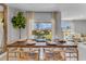 Elegant dining room is set for a dinner party, featuring a large window with bright, natural light at 11148 Amber Ridge Dr, Zellwood, FL 32798