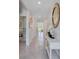 Bright hallway showcasing modern decor, neutral colors, tile flooring, and access to multiple rooms at 11148 Amber Ridge Dr, Zellwood, FL 32798
