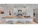 Stylish kitchen island features granite countertops, white cabinets, stainless appliances, and bar seating at 11148 Amber Ridge Dr, Zellwood, FL 32798
