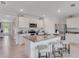 Bright kitchen features granite countertops, stainless appliances, island with bar seating, and tile floors at 11148 Amber Ridge Dr, Zellwood, FL 32798