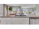 Modern kitchen island boasts granite countertops, stainless steel appliances, and a breakfast bar at 11148 Amber Ridge Dr, Zellwood, FL 32798