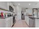 Modern kitchen with stainless steel appliances, granite countertops, and white cabinets at 11148 Amber Ridge Dr, Zellwood, FL 32798