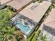 Aerial view of a private pool area with covered seating and well-maintained landscaping at 11763 Eagle Ray Ln, Orlando, FL 32827
