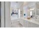 Bright bathroom featuring a soaking tub, dual sink vanity with a framed mirror, and tile flooring at 11763 Eagle Ray Ln, Orlando, FL 32827