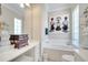 Bathroom showcasing a soaking tub, vanity area, tile flooring, and designer decor at 11763 Eagle Ray Ln, Orlando, FL 32827