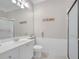 Cozy bathroom featuring a white vanity, toilet, framed mirror, and shower with updated tile work at 11763 Eagle Ray Ln, Orlando, FL 32827