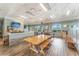 Cozy dining area with a bar, large wooden table, and multiple windows providing natural light at 11763 Eagle Ray Ln, Orlando, FL 32827